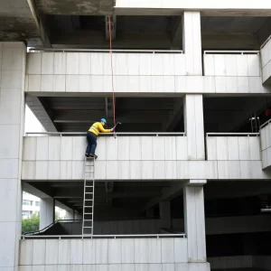 Workers performing maintenance on a precast concrete parking structure