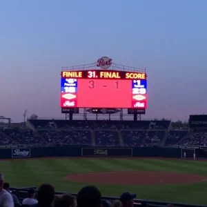 Baseball field with scoreboard showing 3-1 final score.